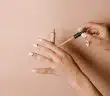 person holding white cigarette stick